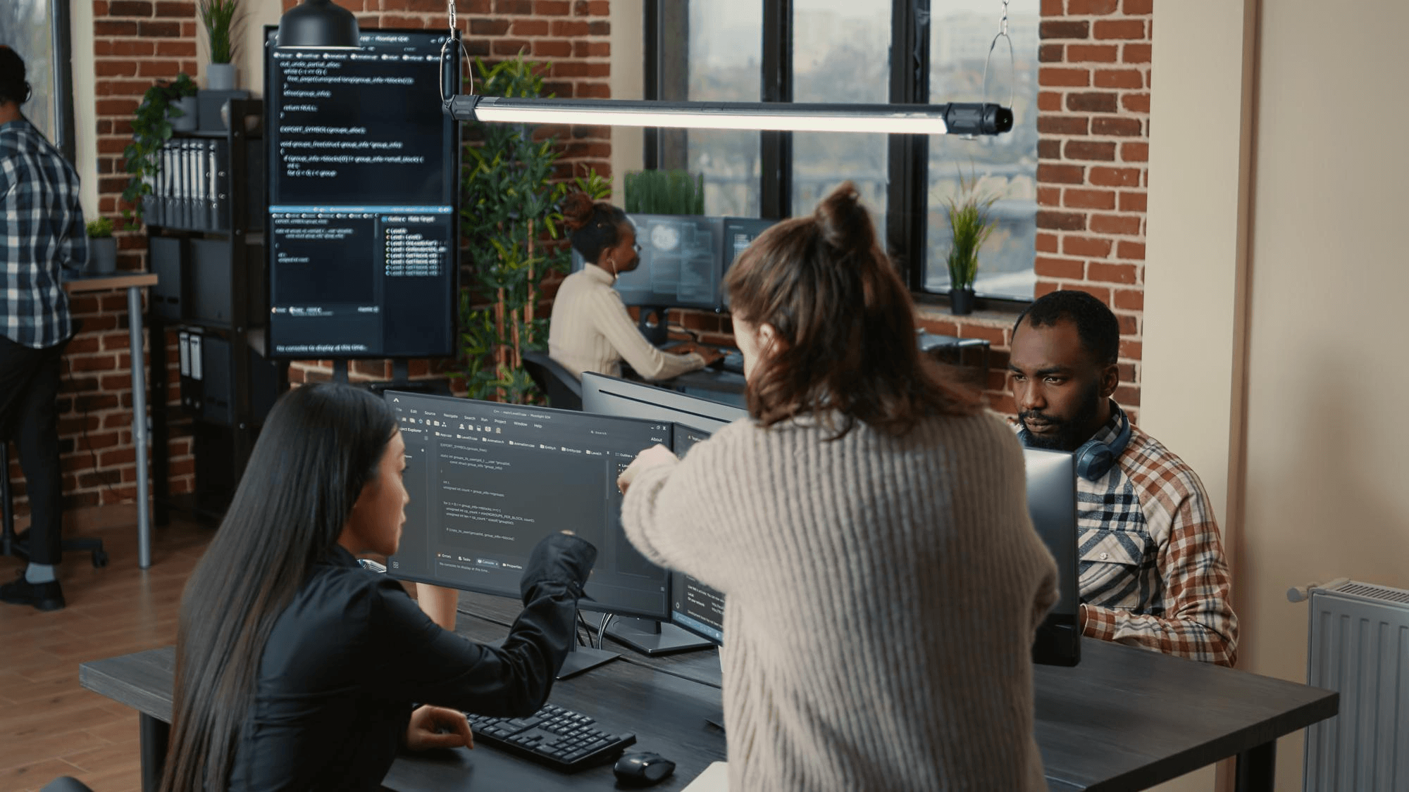 A team collaborating around a clinical software workspace.